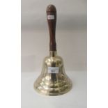 A modern replica of an early 20thC brass school bell, on a turned wooden handle