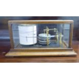 A Negretti and Zambra glazed, oak cased barograph  No.9710  6.5"h  12.5"w