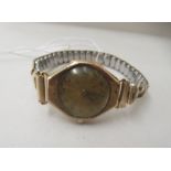 A ladies vintage Rolex wristwatch in a 9ct gold case, faced by an Arabic dial, on a flexible gold