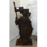 A 20thC cast iron door porter, fashioned as a knight, holding a flagpole  28"h