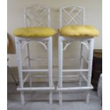 A pair of modern white painted bamboo effect bar stools