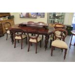 A Victorian style mahogany wind-out dining table, the top comprising a pair of D-ends and two