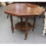 An early 20thC mahogany octagonal occasional table, raised on ring turned legs and casters, united