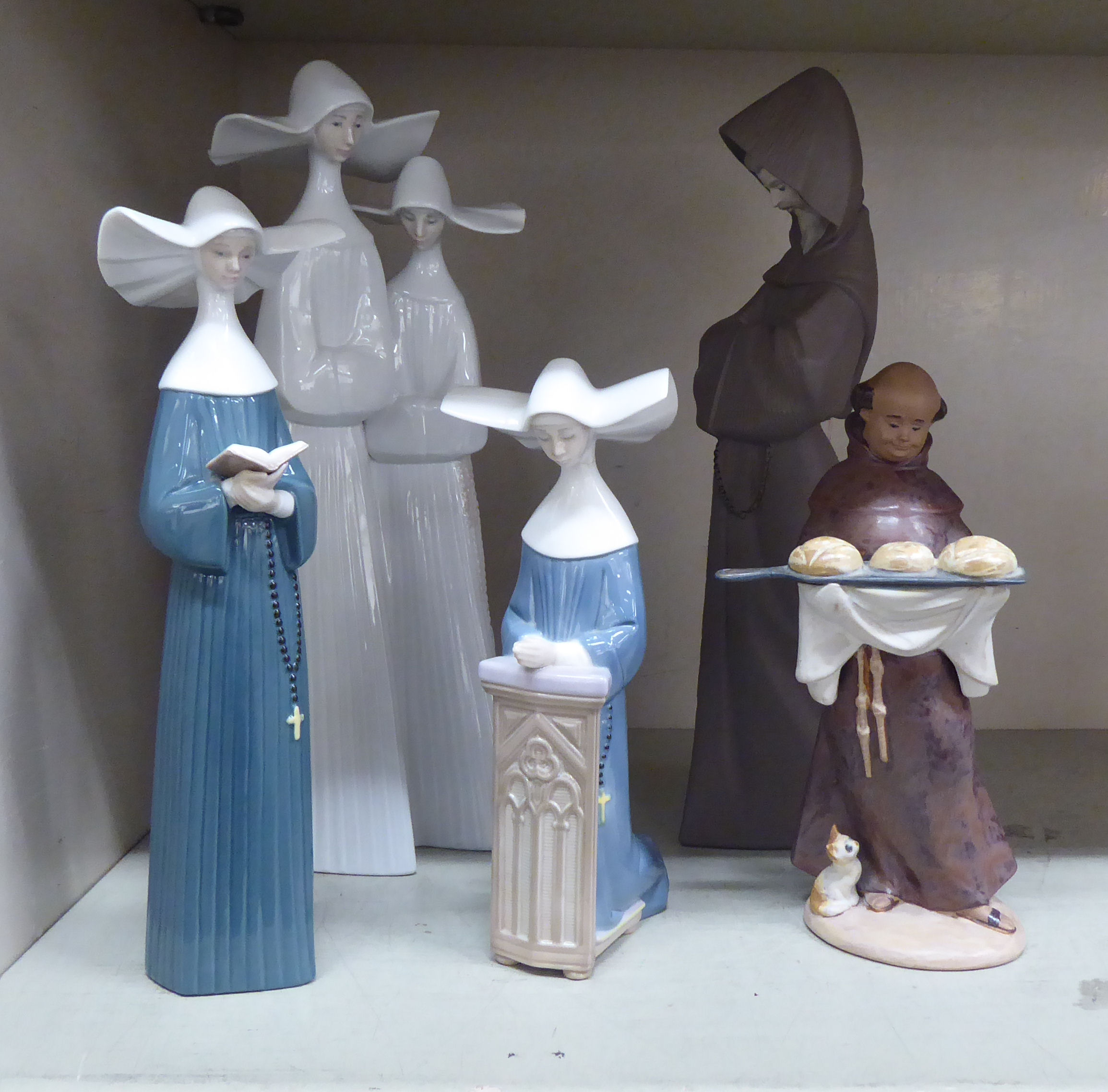 Lladro porcelain figures, depicting nuns and a monk  largest 13.5"h