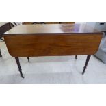A George III mahogany Pembroke table with an end drawer and a facsimile on the obverse, raised on