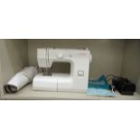 A Janome JF1004 electric sewing machine, in a cream coloured case with instructions and a foot