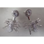 A pair of silver earrings, fashioned as faux diamond encrusted spiders