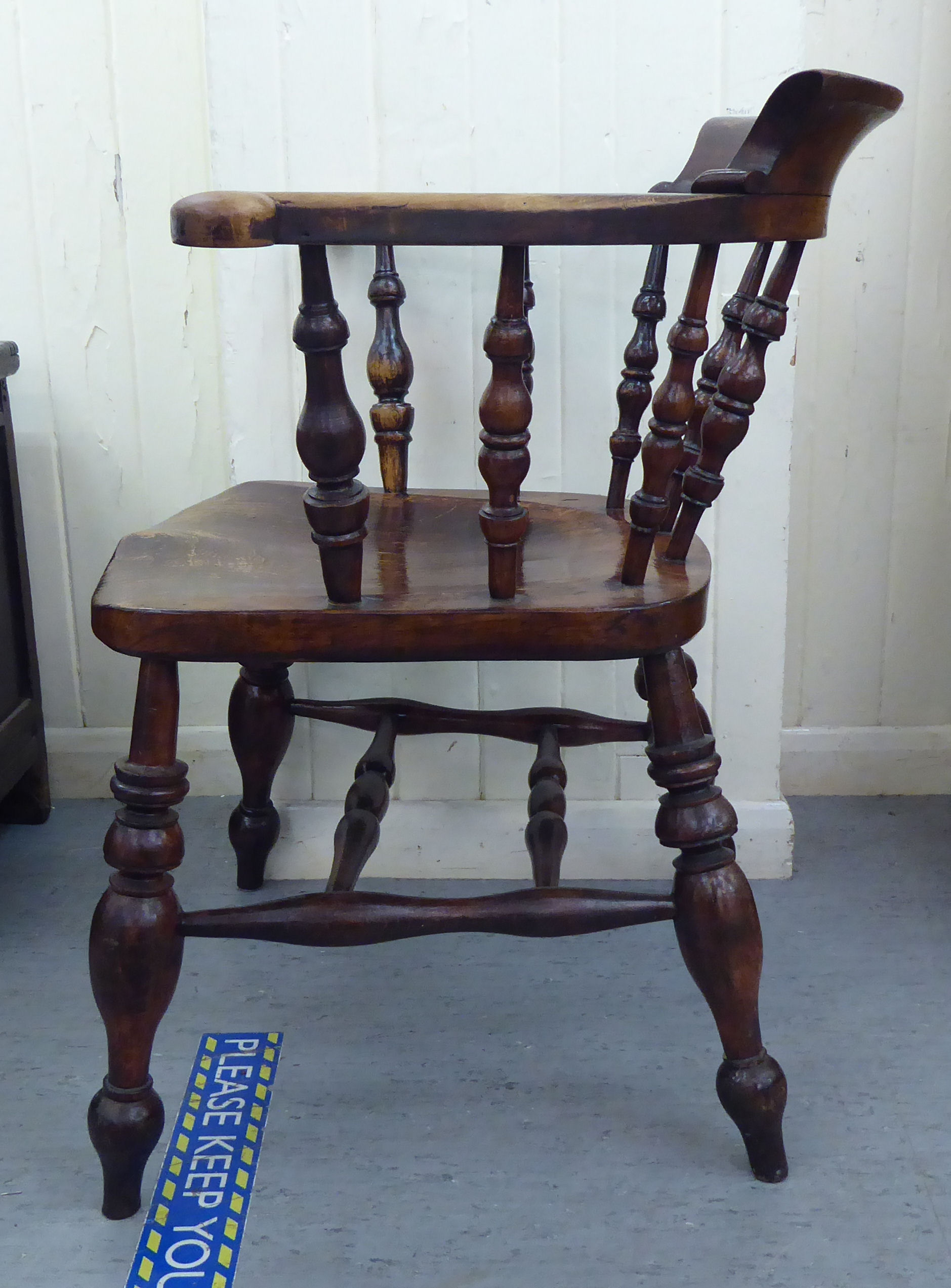 A late 19thC stained beech and elm framed Captains chair, the round back with scrolled level arms, - Image 2 of 4