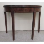 A Regency mahogany demi-lune tea table with a foldover top, raised on square, tapered legs  29"h