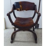 An early 20thC oak framed Savonarola style chair