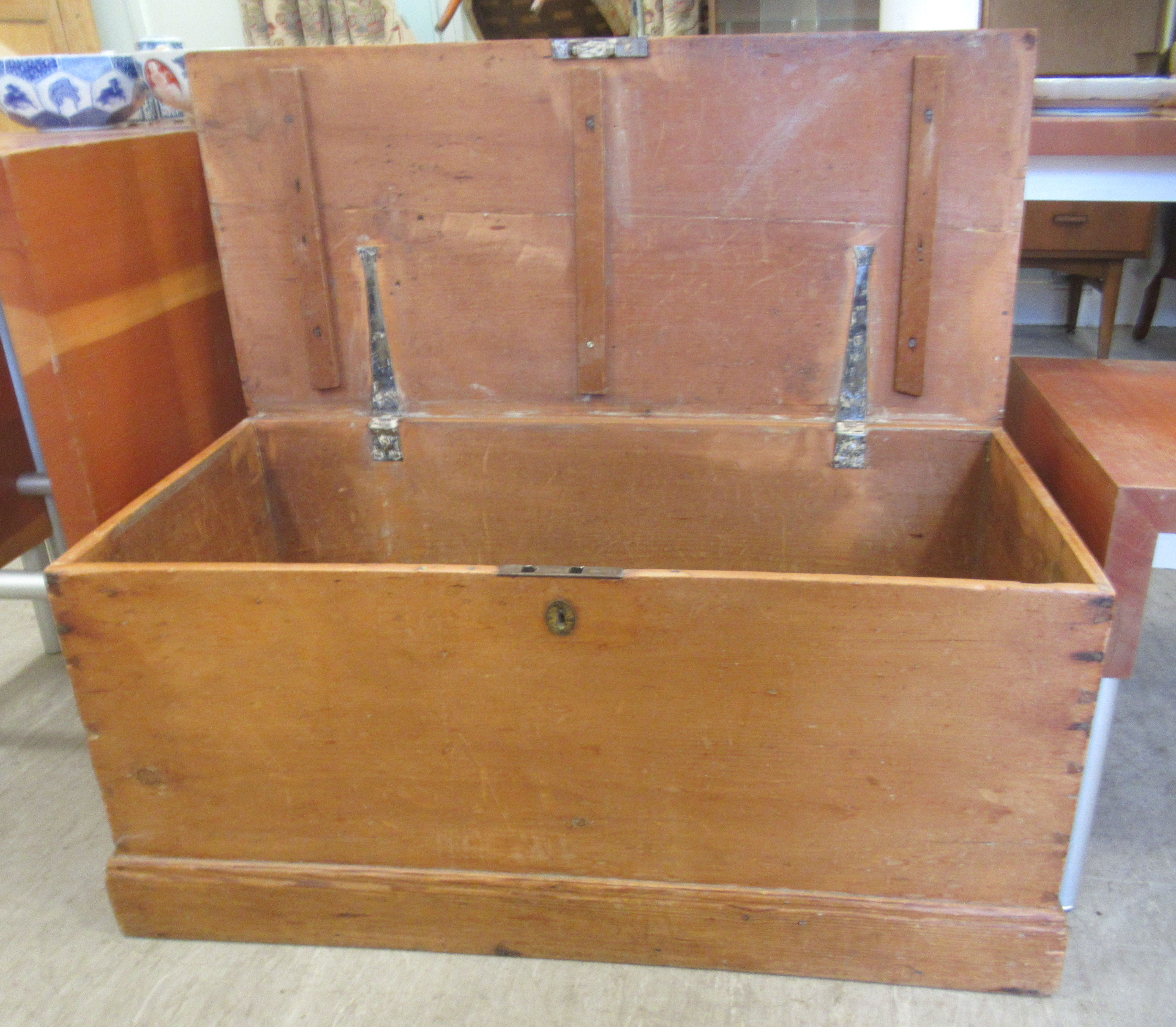 A late 19thC pine trunk with straight sides and a hinged lid, on a plinth  17"h  36"w - Image 2 of 3