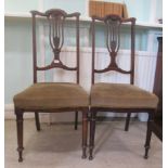 A pair Edwardian beech and walnut framed splat back bedroom chairs, the fabric upholstered seats,