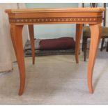 A modern laminated teak effect combination games table, raised on square, tapered, cabriole legs