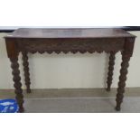 An early 20thC carved oak hall table, raised on bobbin turned legs  30"h  42"w
