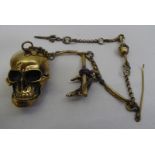 An antique finished brass skeleton themed pocket watch chain