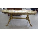 A modern Italianate oval coffee table with a mottled marble top, over an ornately cast metal