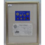 A framed presentation of British pre-decimal coinage; and a banknote dated 1952  12" x 16"