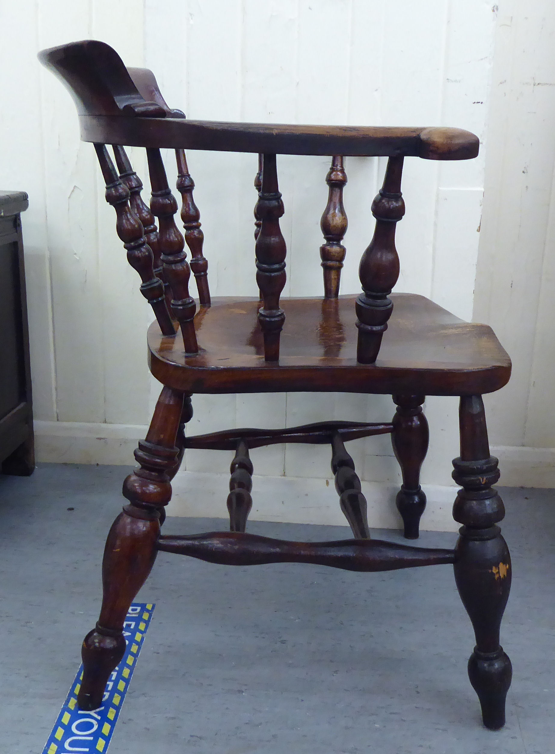 A late 19thC stained beech and elm framed Captains chair, the round back with scrolled level arms, - Image 4 of 4