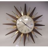 A 1970s Metamec sunburst style wall clock, in a polished brass finished and teak frame; the later,