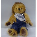 A Merrythought plush covered Teddy bear with a fishing net  13"h