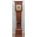 An early 19thC light oak longcase clock, the square hood with a window and flank pillars, over a