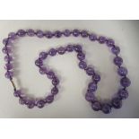 A graduated round bead amethyst necklace, on a bayonet clasp  28"L  approx. weight 6.6ozs