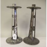 A pair of early 20thC Arts & Crafts spot hammered and rivetted white metal candlesticks of open,