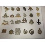 Approx. twenty-four military regimental cap badges and other insignia, some copies: to include