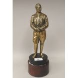 A cast brass statue, a standing uniformed figure of Adolf Hitler  10"h, on a turned wooden plinth (