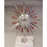 A 1970s Metamac Sunray Lounge Wall Clock, model 892, in a bi-coloured metal and polished teak frame;