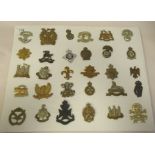 Approx. thirty military regimental cap badges and other insignia, some copies: to include The