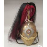 A British military brass cavalry helmet with a red and black plume, chinstrap and liner   (Please