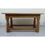 A Robert Thompson 'Mouseman' of Kilburn honey coloured oak coffee table, the top raised on octagonal