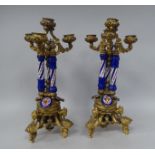 A pair of late 19thC ornately cast gilt metal and porcelain mounted, triple scrolled branch
