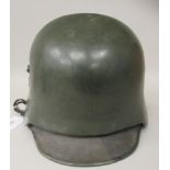 A German World War II military steel helmet with an attached sniper shield, hide liner and chinstrap