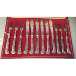 A set of six silver fish knives and forks on scrolled pistol grip handles  G&H  Sheffield 1981, in a