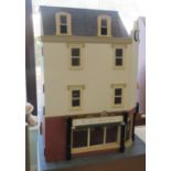 An Enchanted Castles corner property dolls house, incorporating a ground floor shop with two upper