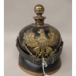 A German World War I brass mounted pickelhaube with a helmet plate and chin strap  (Please Note: