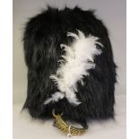 A soldier's bearskin, incorporating a white feathered plume and a brass chain chinstrap  (Please