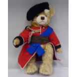 A plush covered Teddy bear, issued to commemorate the 80th Birthday of Her Majesty The Queen