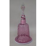 A cranberry coloured glass wrythen moulded table with a swirling red and white handle  10.5"h