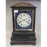 A mid 19thC black lacquered and bi-coloured metal inlaid mantel clock with an arched top and window,