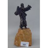 A silver coloured metal figure, Moses holding tablets of stone, on a rocky plinth  8"h overall