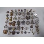 Over forty miscellaneous Scottish military regimental cap badges and other insignia, some copies: