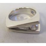 A modern white gold coloured metal, single stone set diamond ring