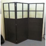 A modern black ash framed three fold, glazed and panelled dressing room screen  each panel 64"h