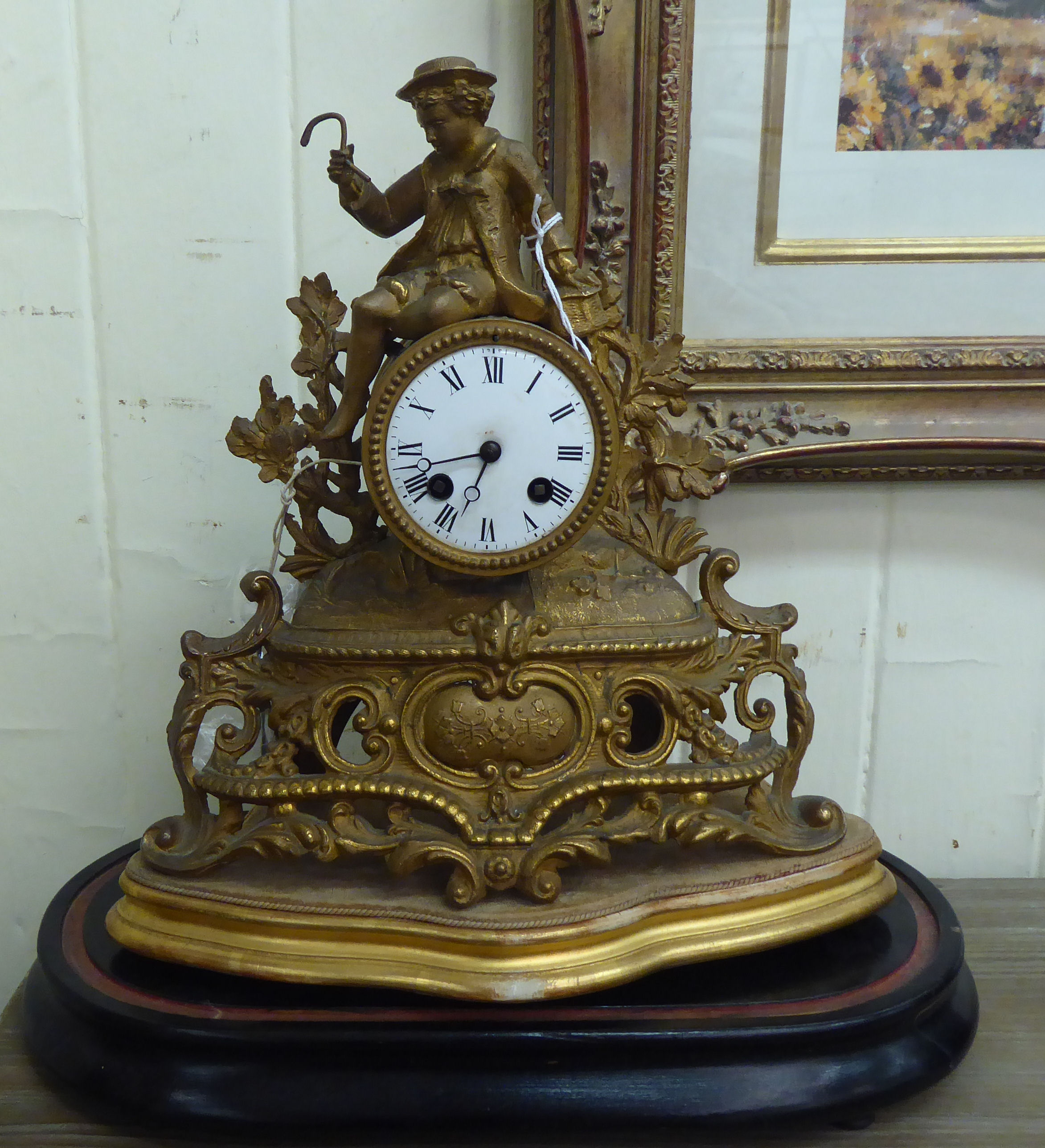 An early 20thC (probably French) gilt metal mantel clock, fashioned as a figure wearing period