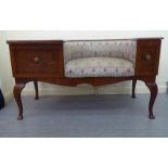 A 1970/1980s mahogany finished telephone seat with a concave Art Nouveau inspired, fabric
