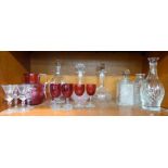 Glassware: to include a clear and cranberry coloured cordial jug and six decanters