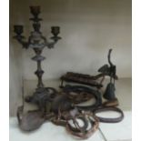 A late 19thC cast iron cork press; and an iron triple branch candlestick  14"h